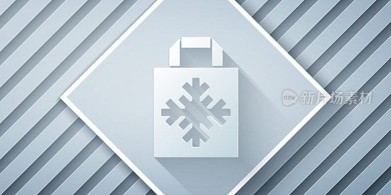 Paper cut Christmas paper shopping bag with snowflake icon isolated on grey background. Package sign. Merry Christmas and Happy New Year. Paper art style. Vector